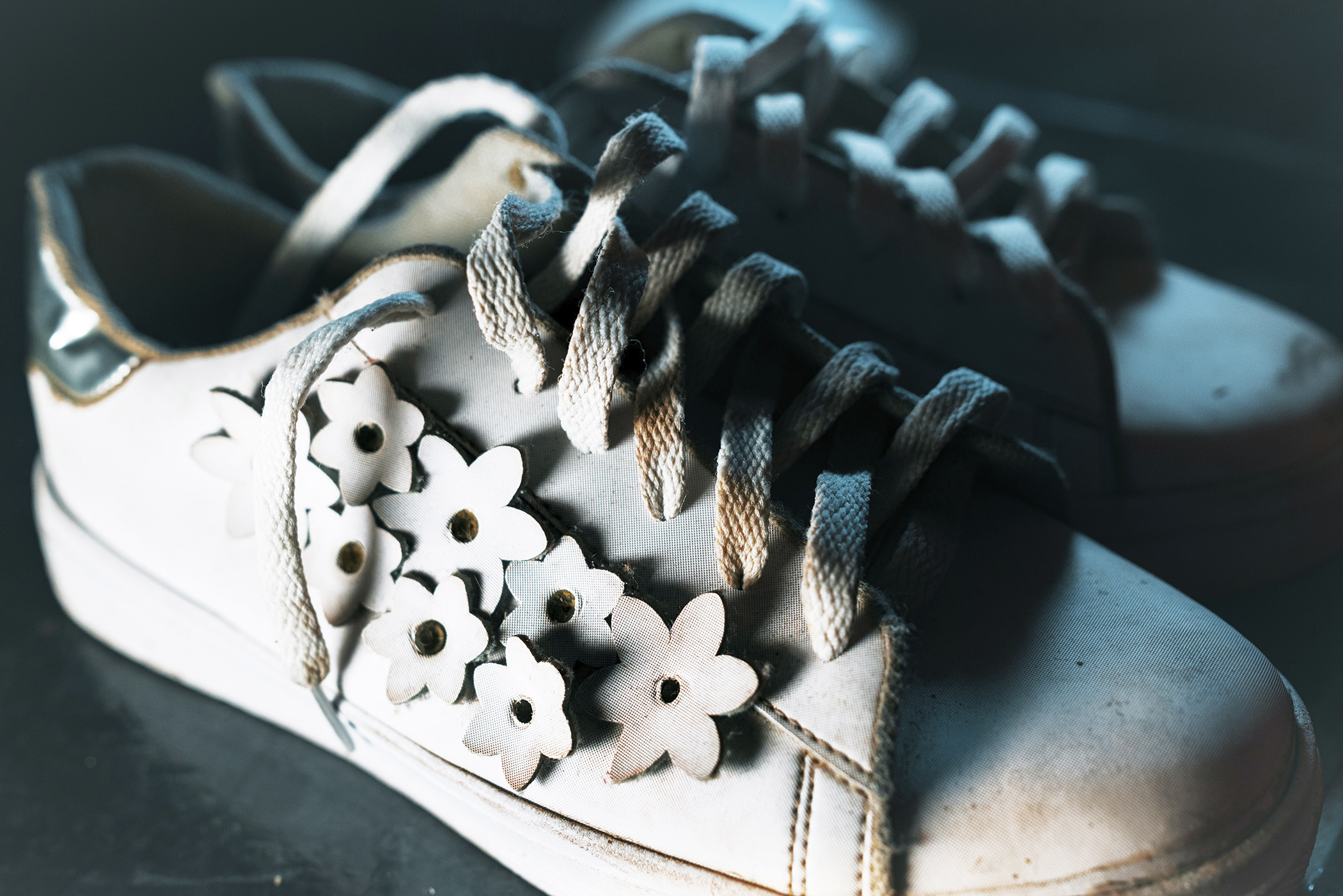 Zapatos deportivos con flores recortadas y cordones desamarrados